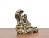 Side view of small brass Maa Lakshmi and Lord Vishnu idol with textured base