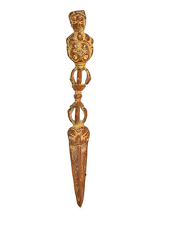 Brass-toned furba phurpa dagger pendant with carved deity figure and looped rings