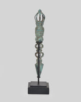 Vintage bronze phurpa ritual dagger on dark base, pointed blade with crown top