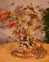 Gold-tone Radha Krishna statue seated under ornate tree with birds, detailed round base