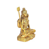 Brass Shiva idol statue angled view, trident held high, detailed face and torso