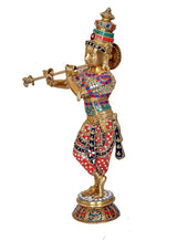 Standing Krishna brass idol, side view holding flute, red and blue patterned garments