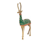 Brass reindeer figurine, green patterned body with red collar and hoof accents, angled view