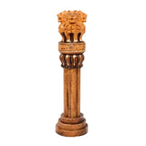 Front view of wooden Ashoka stambh emblem: lion capital atop fluted column