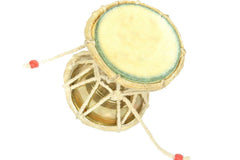 Handmade brass damroo/damru side view with rope net and circular drumhead