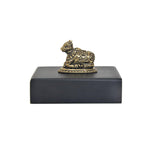 Brass Nandi bull statue on dark rectangular base, side view