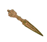 Multicolored brass furba dagger pendant angled view, carved grip and tapering blade
