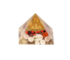 Orgonite chakra pyramid with gold cap, red bead border, and white shell pieces
