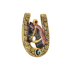 Small gold metal horseshoe ornament with painted horse head and blue evil-eye bead