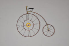 Bicycle wall clock wall decor in iron with two circular wheels and yellow hub center.