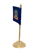 Desk flag from angle: navy flag with golden crest, finial top, gold brass base