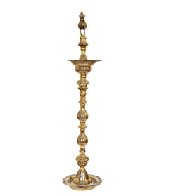 Brass oil lamp holder stand with peacock topper, stacked decorative tiers and circular base