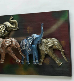 Close-up iron running elephants wall decor with LED lights, blue and gold elephant pair