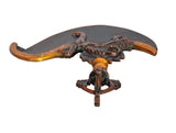 Brass dorje flaying knife top, dark crescent blade with orange-gold grips and central emblem