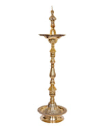 Brass diya lamp stand with vertical stem, top peacock finial and round dish base