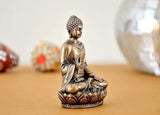 Rear view: gold-tone Buddha resin statue, seated with head bowed on lotus base
