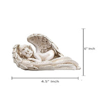 White resin angel cupid statue (4.5 in x 6 in), lying in feathered nest