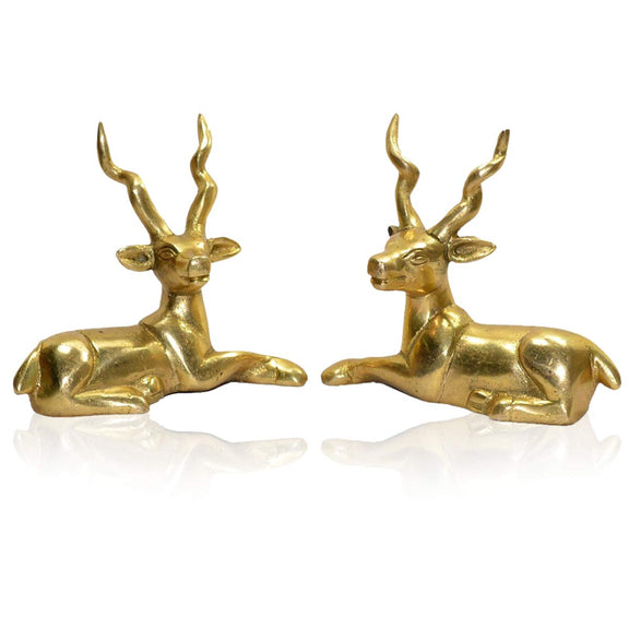 Gold-tone sitting deer figurines facing forward, twin antlers and detailed ears