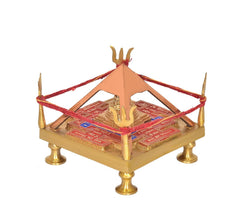 Brass Shri Yantra chowki angled view, red thread band, gold temple pillar on patterned base