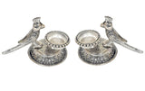 Pair of silver-tone parrot oil diyas with round reservoirs and engraved base patterns