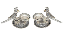 Pair of silver-tone parrot oil diyas with round reservoirs and engraved base patterns
