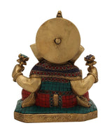 Back view of brass Ganesha statue, round backplate, seated with jeweled waistband