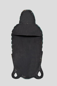 Back of black wooden Buddha mask wall hanging with two hanging openings at the bottom