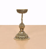 Brass peacock diya lamp stand with upright figure, slender support, round pedestal