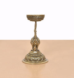Brass peacock diya lamp stand with upright figure, slender support, round pedestal