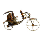 Metal ant rickshaw showpiece with umbrella, gold-toned ant riders and curved wheels