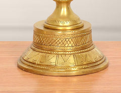 Close-up of brass diya shankh base with engraved diamond and line patterns