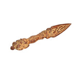 Brass phurba dagger pendant angled view, ornate grip and sharp triangular blade