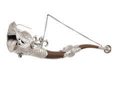 Metal dragon trumpet horn wall hanging close-up: silver dragon head, brown horn tube