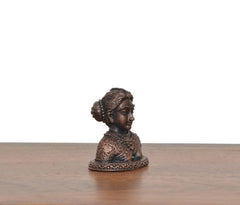 Copper Gowri Idol side view, copper-tone with detailed facial features and crown
