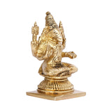 Brass tone deity idol statue, side view of seated figure with raised hands and crown
