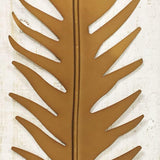 Close-up of gold metal leaf relief in wooden frame