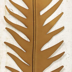 Close-up of gold metal leaf relief in wooden frame