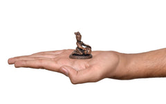 Copper Lord Bal Gopal Krishna 2 inch idol statue on an open palm for scale
