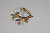 Iron birds wall decor: gold-tone birds perched on a branch, circular white backplate