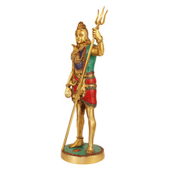 Brass standing Bholenath idol front view, raised trident, patterned green top and red skirt