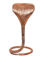 Copper naag idol stand close view: hammered hood and coiled base ring