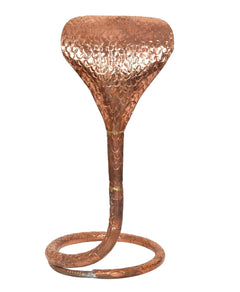 Copper naag idol stand close view: hammered hood and coiled base ring