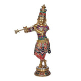 Brass Krishna idol statue with flute, ornate jeweled attire, standing on decorated base