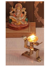 Brass diya on swastik deepam, 4 inch, standing holder with lit flame in bowl