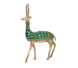 Gold-tone reindeer ornament with green dotted coat, red trim, standing full-body side view