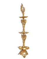 Brass oil lamp stand with peacock ornament, three flame bowls and carved base