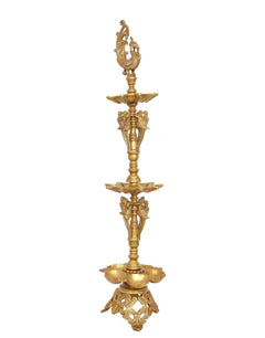 Brass oil lamp stand with peacock ornament, three flame bowls and carved base