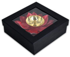 Pink lotus metal diya in black square frame, gold bowl centered on red petal design