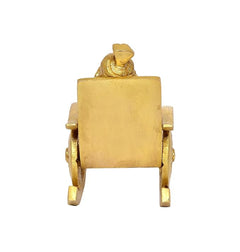 Back view of golden brass Ganesha statue on chair with rectangular backrest