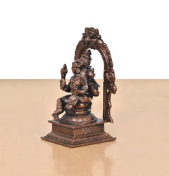 Rear/angled view of copper Lakshmi Narasimhar idol with ornate arch and pedestal